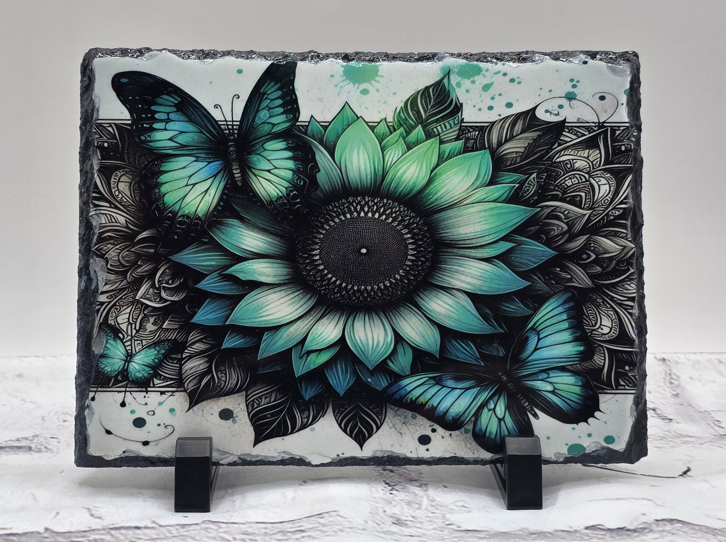Decorative slate with a floral and butterfly design on a white background