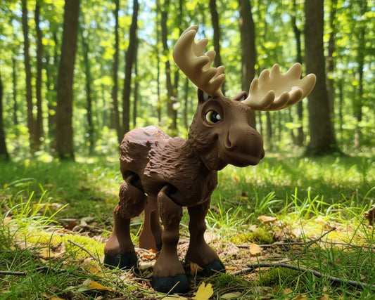 A small moose figurine or toy with a brown body, beige antlers, and black hooves.