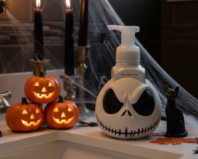 A Jack themed pump bottle with a white and black design, featuring his stitched smile and eye sockets, set against a white studio background.