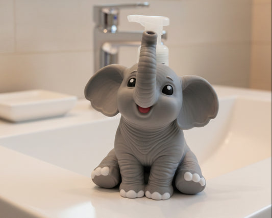 A gray baby elephant-shaped pump bottle with a smiling face, large ears, and a clear plastic pump on top, photographed against a white studio background.